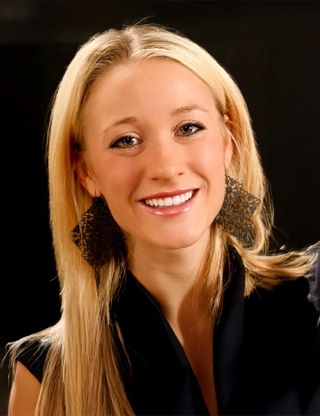 Blonde woman grinning after a smile makeover from her Windermere dentist